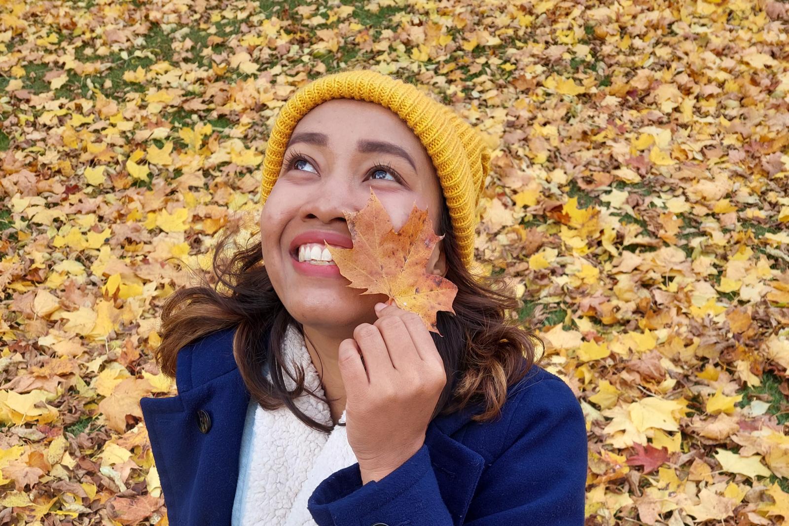 Rosi outdoors in autumn, holding a leaf